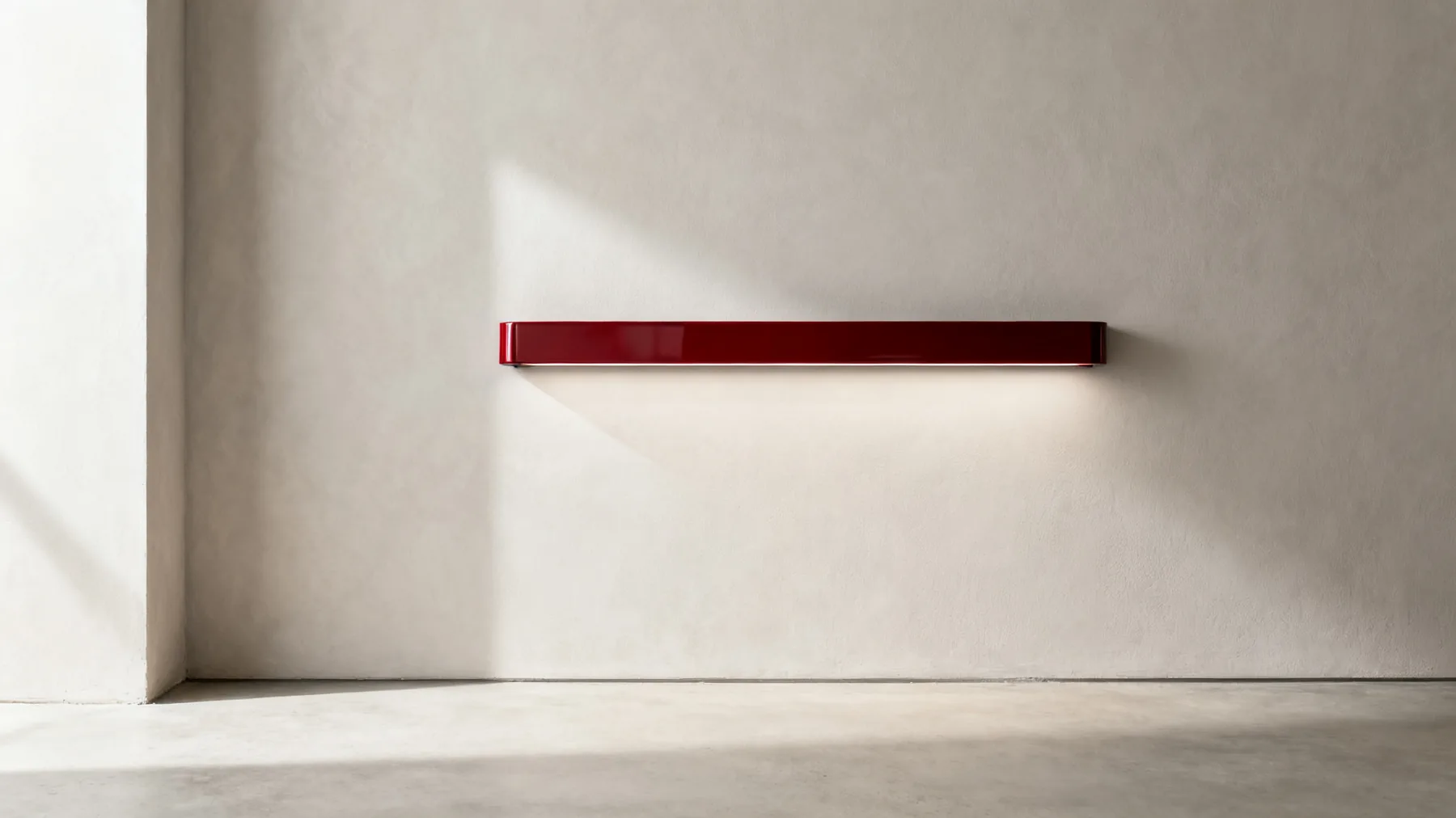 The Coachline 900 in racing red, wall-mounted in daylight with the light switched off